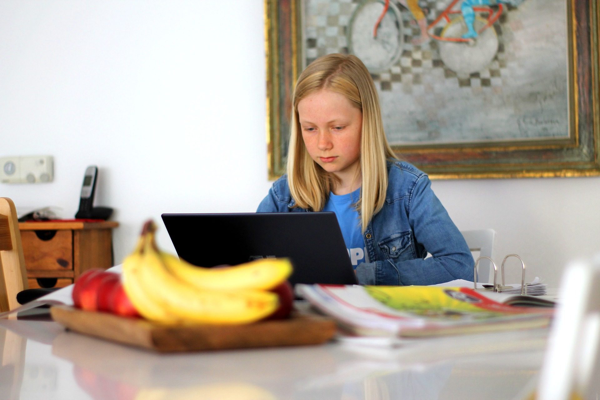 Young girl sat at a desk taking an eLearning course